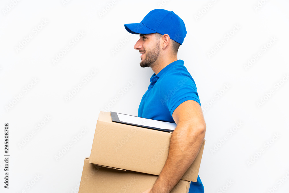 Delivery man over isolated white background looking to the side Delivery man over isolated white background looking to the side
