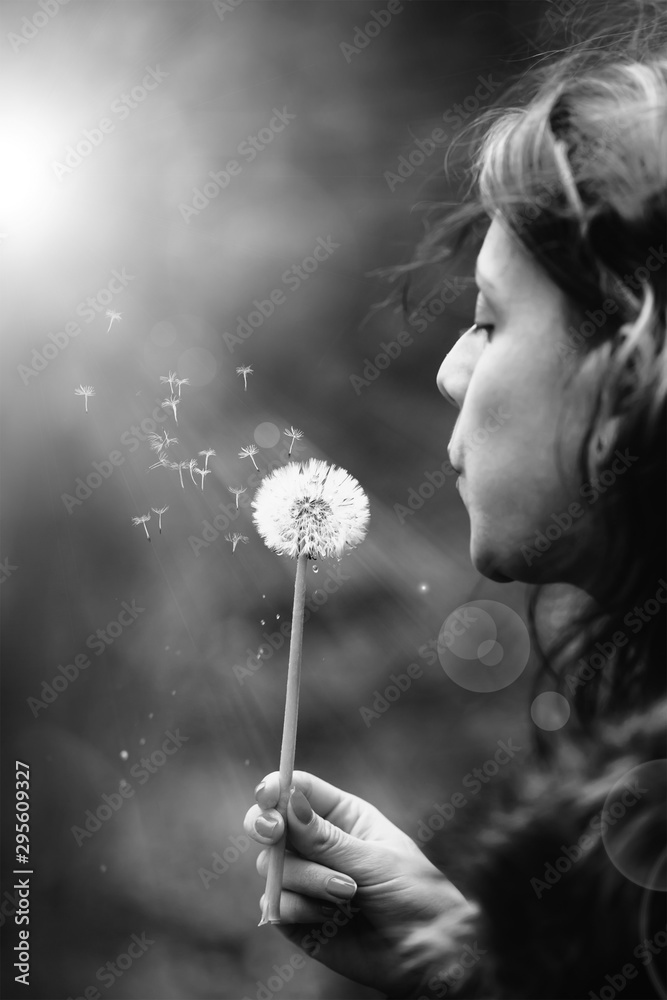 Smiling beautiful girl in wreath of dandelions closed her eyes with dandelions in summer park, concept of summer mood. Black and white image Smiling beautiful girl in wreath of dandelions closed her eyes with dandelions in summer park, concept of summer mood. Black and white image