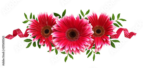 Pink gerbera flowers, green leaves and silk ribbons in a floral arrangement photo