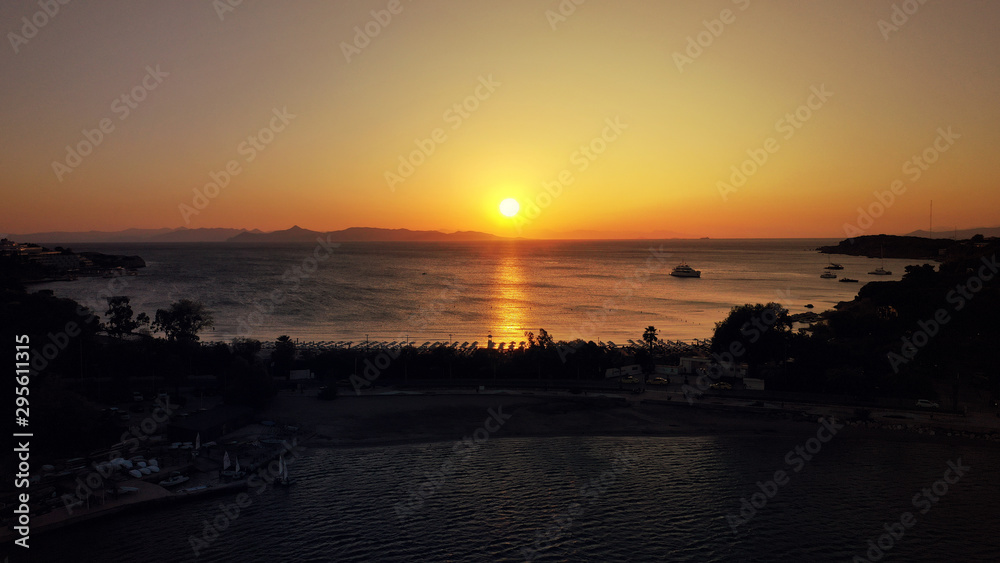 Aerial drone photo of iconic Astir or Asteras celebrity beach featuring ancient Apollo Zoster Temple in the heart of Athens Riviera with golden colours at sunset, Vouligameni, Attica, Greece