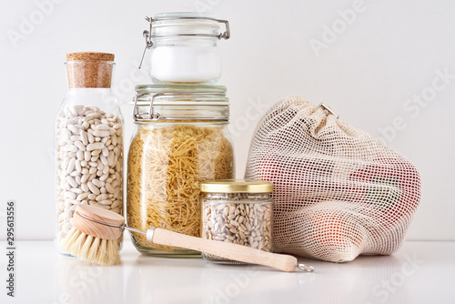 Glass jars with food ingredients on a white background. Zero waste concept. Kitchen background with eco friendly utensils