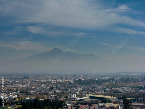 view of the volcano Iztaccihuatl volcanoes in Puebla through the fog. concept of two worlds terrestrial and celestial
