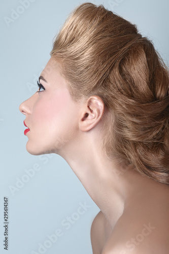 Portrait of a young blonde girl in retro hairstyle