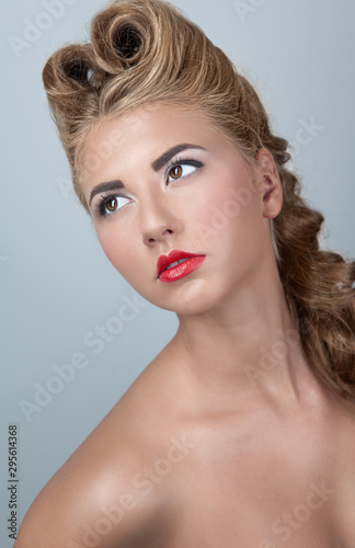 Portrait of a young blonde girl in retro hairstyle