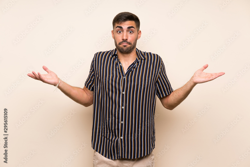 Handsome man with beard over isolated background having doubts with confuse face expression Handsome man with beard over isolated background having doubts with confuse face expression