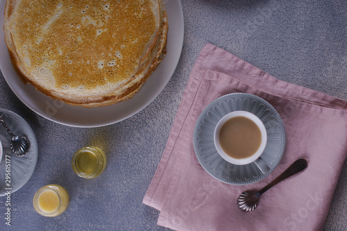 Breakfast with pancakes on a textured background