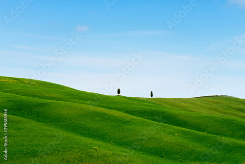 Beautiful spring minimalistic landscape with green hills in Tuscany