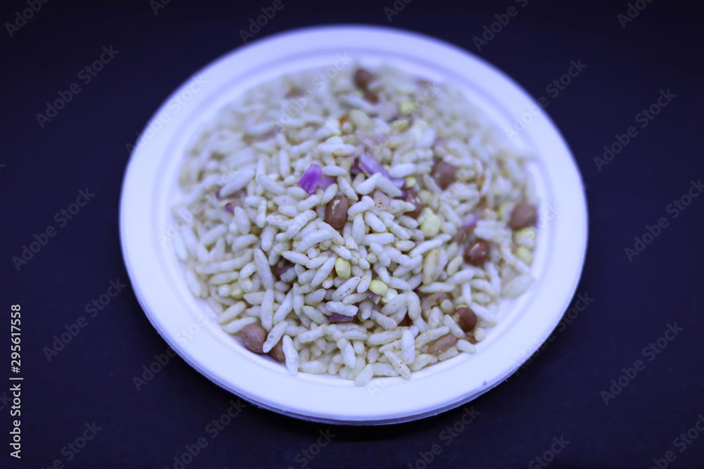 Saraswathi Pooja and Ayudha Pooja Celebrations - pori kadalai and onion in white bowl on black background. Saraswathi Pooja and Ayudha Pooja Celebrations - pori kadalai and onion in white bowl on black background.