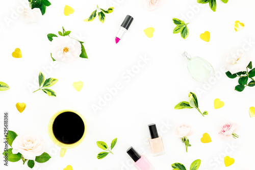 Feminine composition with roses flowers, cosmetics and coffee mug on white background. Flat lay