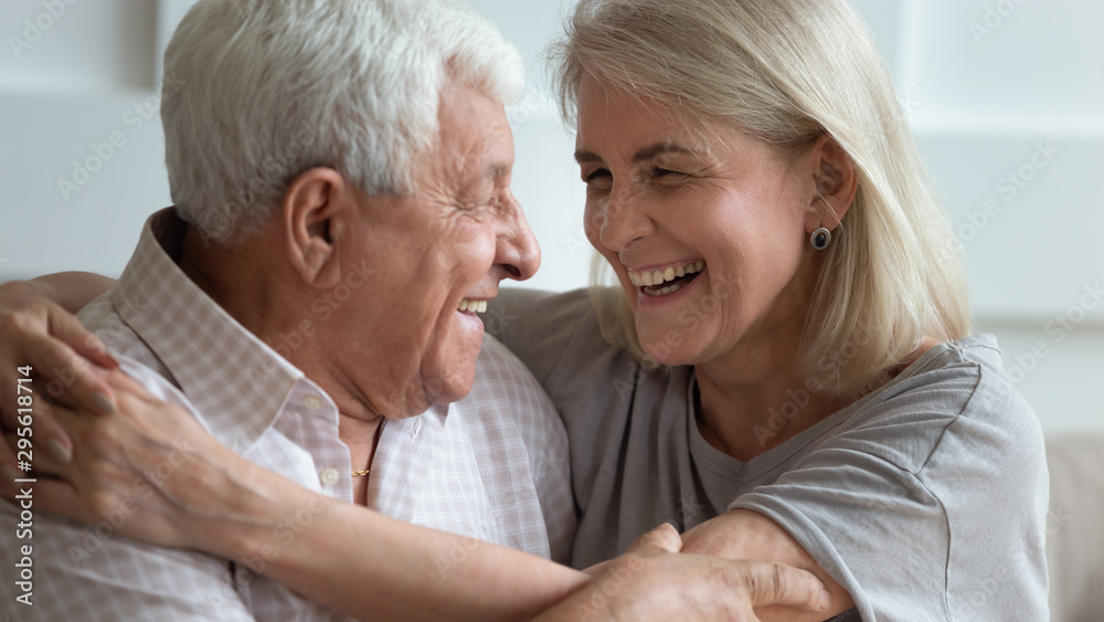 Close up faces elderly wife and senior husband embracing indoors Close up faces elderly wife and senior husband embracing indoors