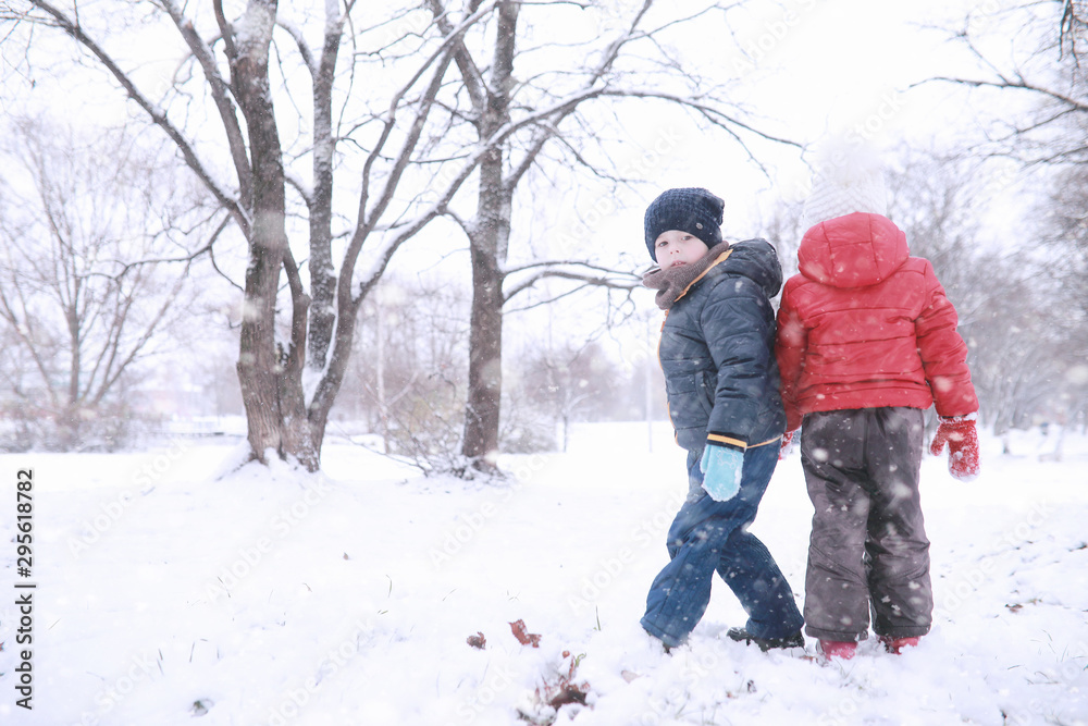 Kids walk in the park first snow Kids walk in the park first snow