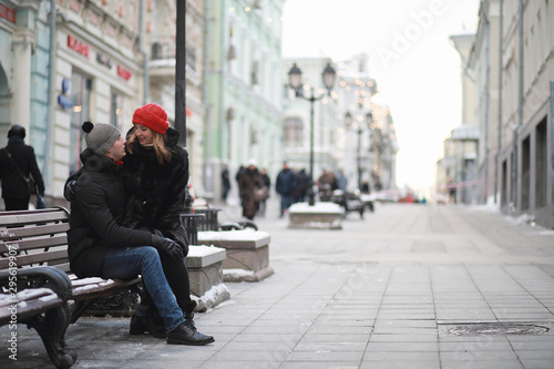 Young couple walking through the winter © alexkich