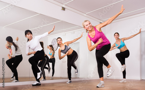 Fototapeta Naklejka Na Ścianę i Meble -  Cheerful different ages women learning swing steps at dance class
