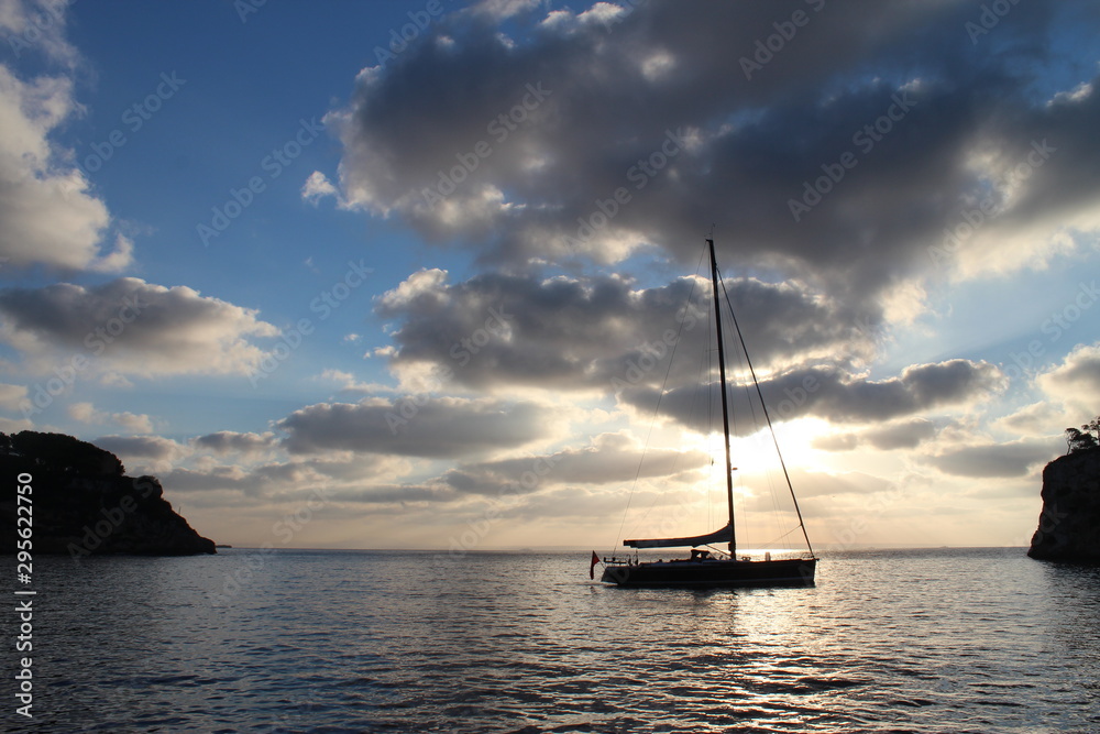 sailboat at sunset with clouds in Greece
