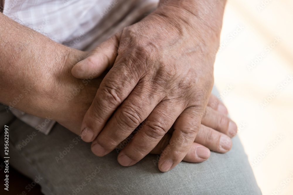 Close up folded together hands of elderly man Close up folded together hands of elderly man