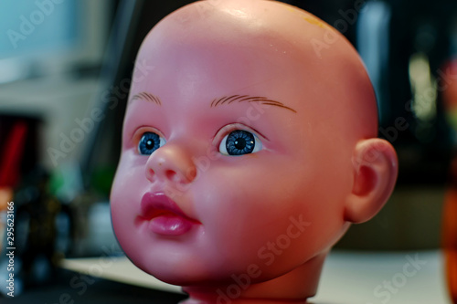 beautiful bald doll head close-up with beautiful blue expressive eyes