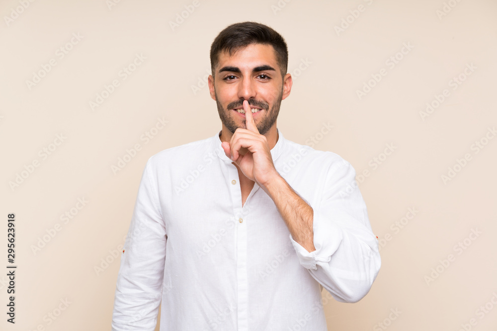 Handsome man with beard over isolated background doing silence gesture Handsome man with beard over isolated background doing silence gesture