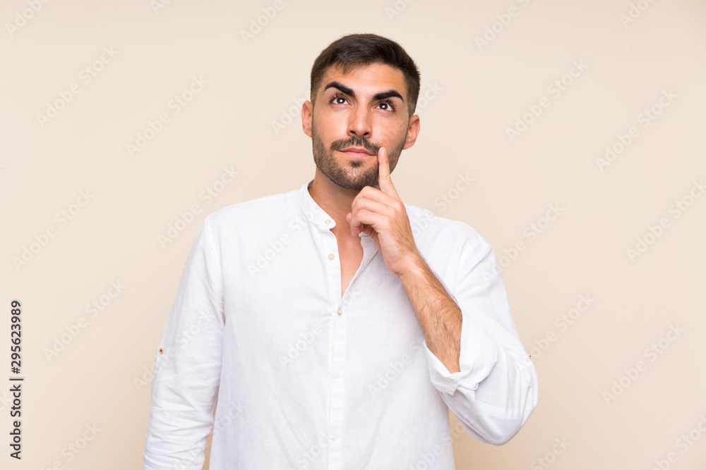 Handsome man with beard over isolated background thinking an idea Handsome man with beard over isolated background thinking an idea