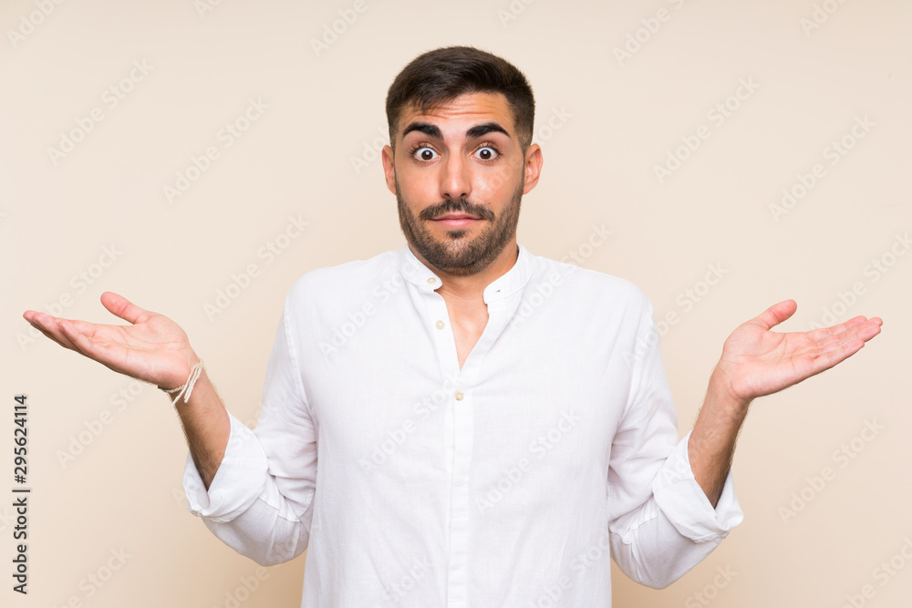 Handsome man with beard over isolated background having doubts with confuse face expression Handsome man with beard over isolated background having doubts with confuse face expression