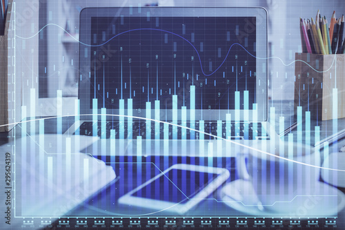 Forex market chart hologram and personal computer background. Multi exposure. Concept of investment. © peshkova