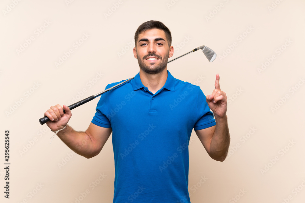 Young handsome golfer man over isolated background pointing up a great idea