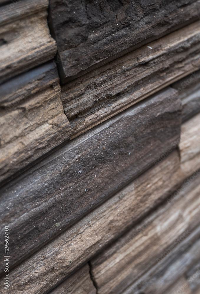 Natural stone bricks as a decoration on a wall. Natural stone wall texture. The walls are made of stones or marbles. Decoration for the walls or febces. Natural stone bricks as a decoration on a wall. Natural stone wall texture. The walls are made of stones or marbles. Decoration for the walls or febces.