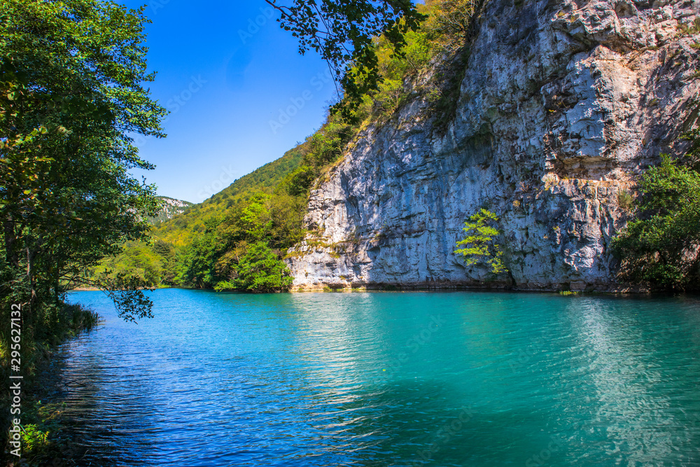 Beautiful and turquoise river Una in canyon on the Croatian and Bosnia and Herzegovina border. Forest and mountains next to the river.