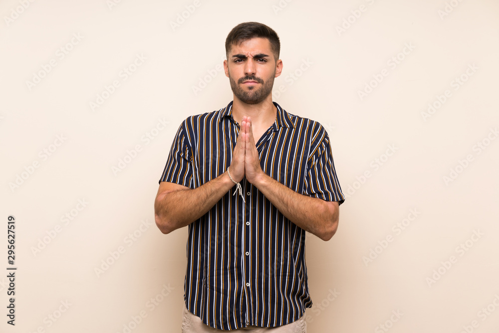 Handsome man with beard over isolated background pleading Handsome man with beard over isolated background pleading