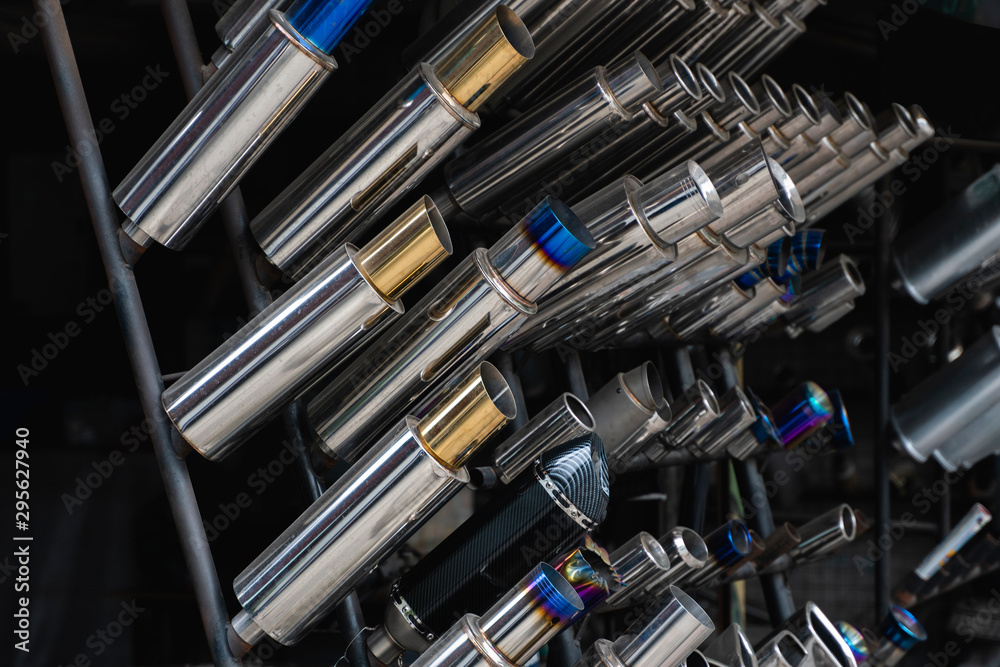 New and used motorcycle exhaust chrome pipes in a motorcykles shop or in service center. New and used motorcycle exhaust chrome pipes in a motorcykles shop or in service center.