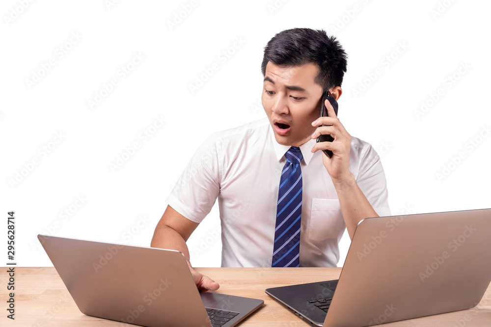 Asian business man talking on the phone scared in shock with a surprise face Asian business man talking on the phone scared in shock with a surprise face