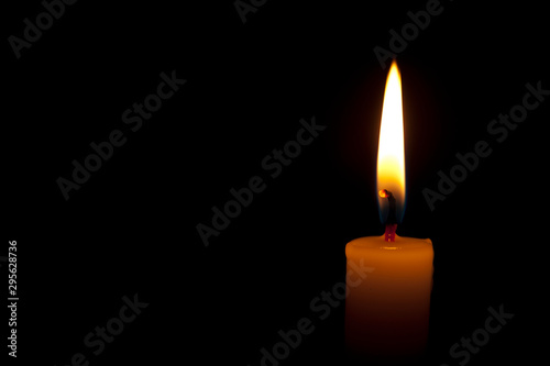 Wallpaper Mural Horizontal photo of lighted candle isolated on black background