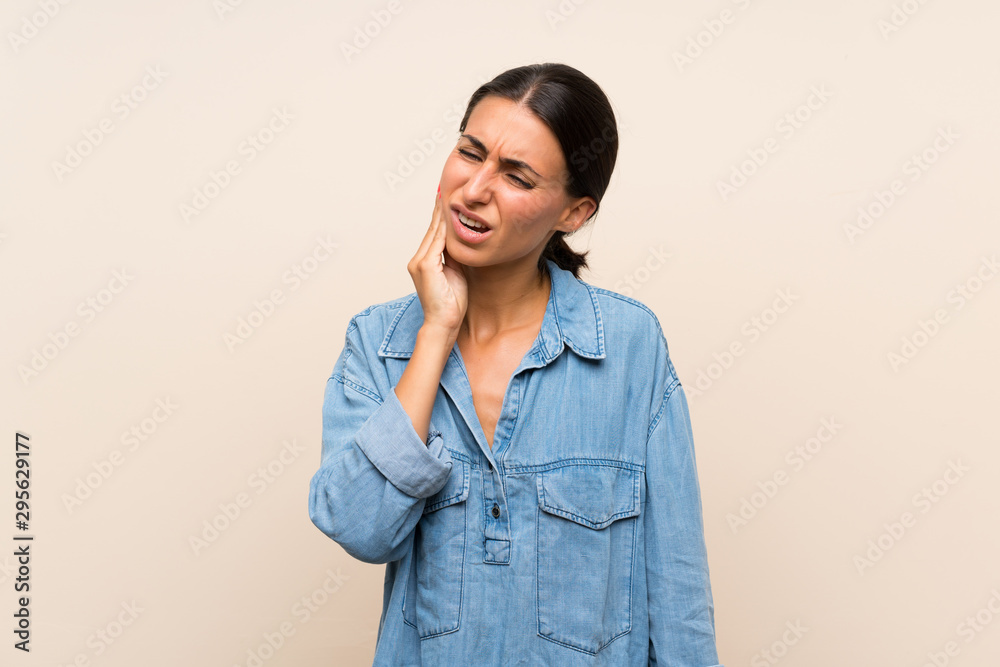 Young woman over isolated background with toothache Young woman over isolated background with toothache