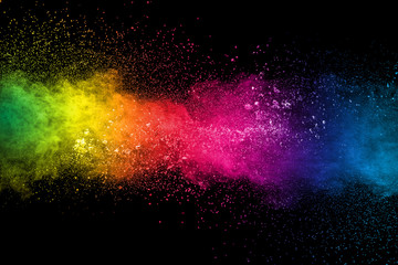 Colorful background of pastel powder explosion.Multi colored dust splash on black background.Painted Holi.