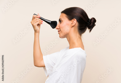 Young woman holding a makeup brush
