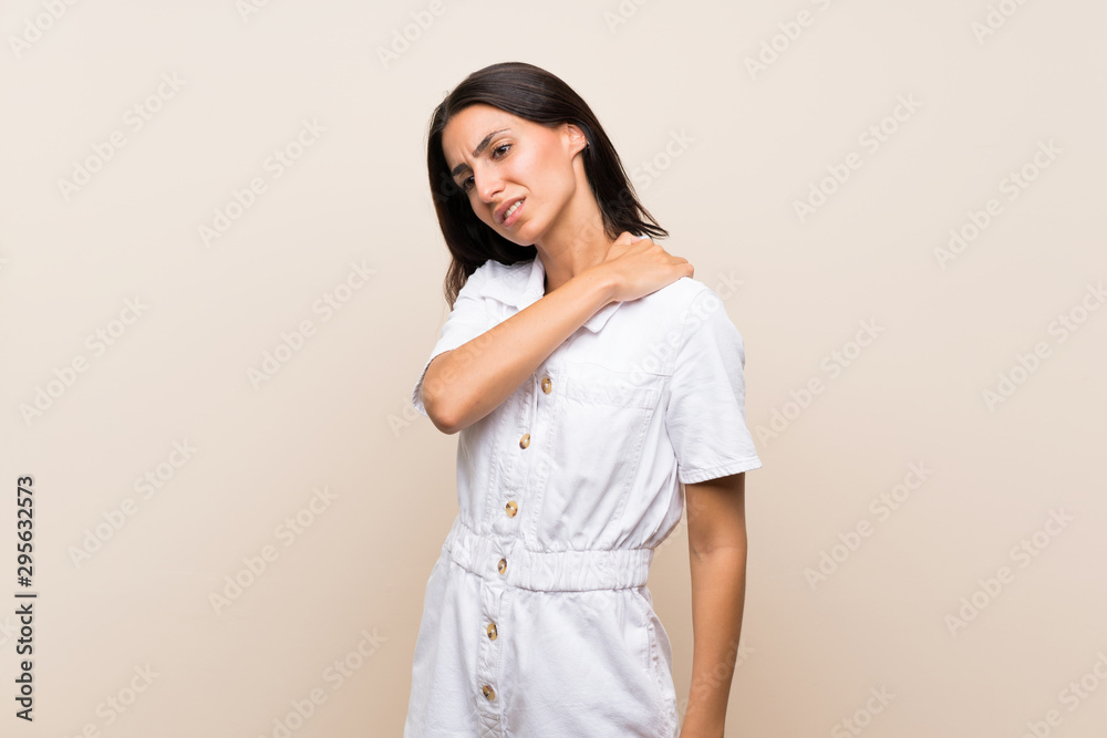 Young woman over isolated background suffering from pain in shoulder for having made an effort Young woman over isolated background suffering from pain in shoulder for having made an effort