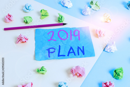Conceptual hand writing showing 2019 Plan. Concept meaning setting up your goals and plans for the current year or in 2019 Colored crumpled paper empty reminder blue yellow clothespin © Artur