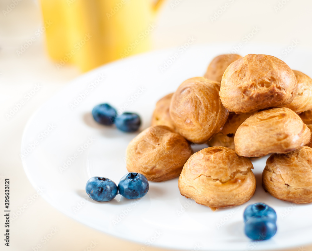 profiteroles with Blueberries on a white plate