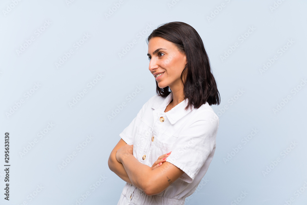 Young woman over isolated blue background looking to the side Young woman over isolated blue background looking to the side
