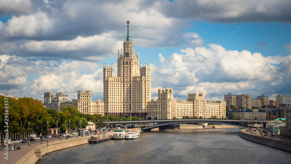 Obraz premium Moscow. Russia. High-rise building on Kotelnicheskaya embankment under gray clouds. Panorama of Moscow. Architecture of the capital of the Russian Federation. Gray water in the river Moscow.Boat trips