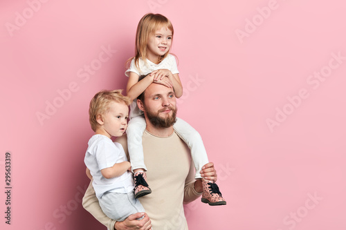 handsoome bearded dad and his children waching TV indoors, clloe up side view photo.copy space. people