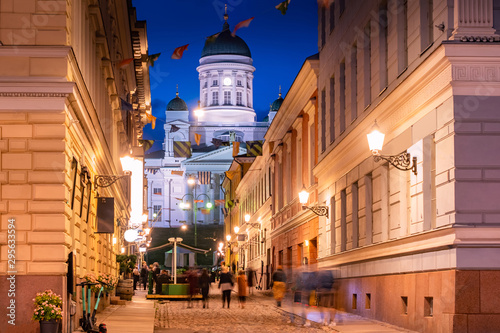 Helsinki. Finland. Suurkirkko. Cathedral Of St. Nicholas. Cathedrals Of Finland. The street leads to Helsinki Senate square. Helsinki travel guide. Architecture. White Church with dark domes. photo