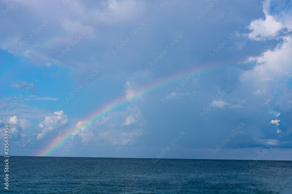 Rainbow over the calm Black Sea in Sochi in the morning