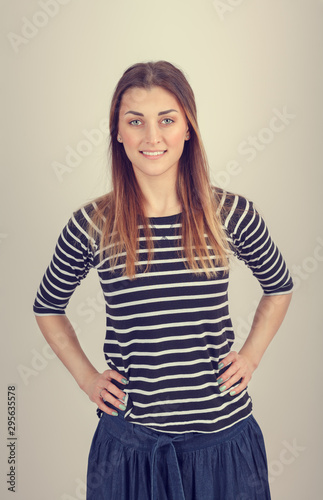 Portrait of a beautiful young girl in a striped sweater