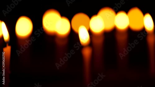 Burning Candles Blur To Focus Clip. Diwali festive rack focus video of candles burning and glowing at celebration night for church, temple or monastery rituals and tradition.