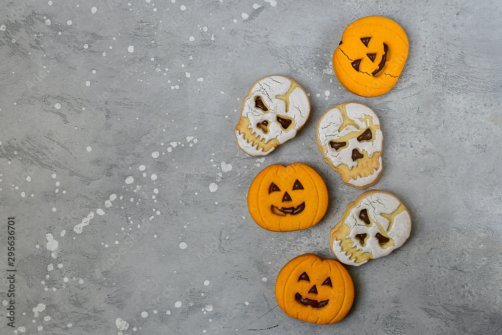 Jack O Lanterns pumpkin shaped cookies and skull shaped cookies with a glass of milk. Halloween kids breakfast. Jack O Lanterns pumpkin shaped cookies and skull shaped cookies with a glass of milk. Halloween kids breakfast.