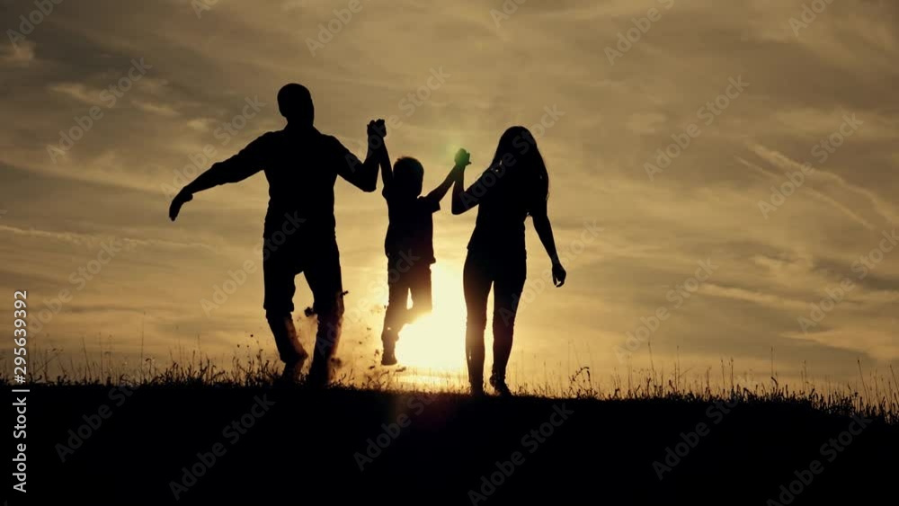 Happy family at sunset go hand in hand forward. The view from the back. Happy family at sunset go hand in hand forward. The view from the back.