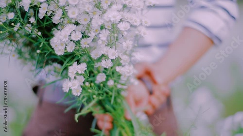 A white flower field and a bouquet of flowers on an important day that a woman dreams of