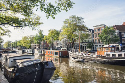 Street and canals in Amsterdam old town, Netherlands. Popular travel destination and tourist attraction