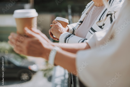 Woman hands holding paper cups of coffee