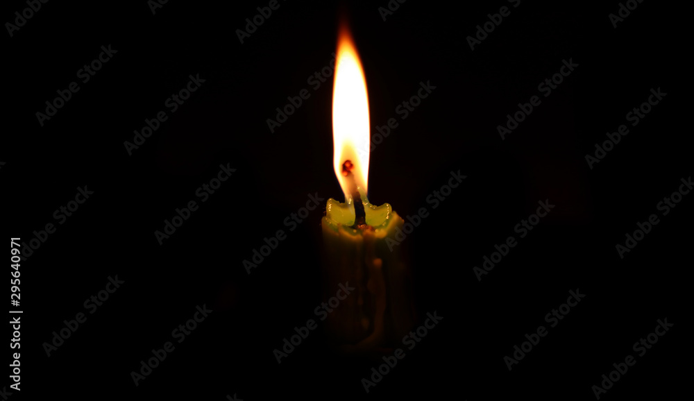light candle burning brightly in the black background. light candle burning brightly in the black background.